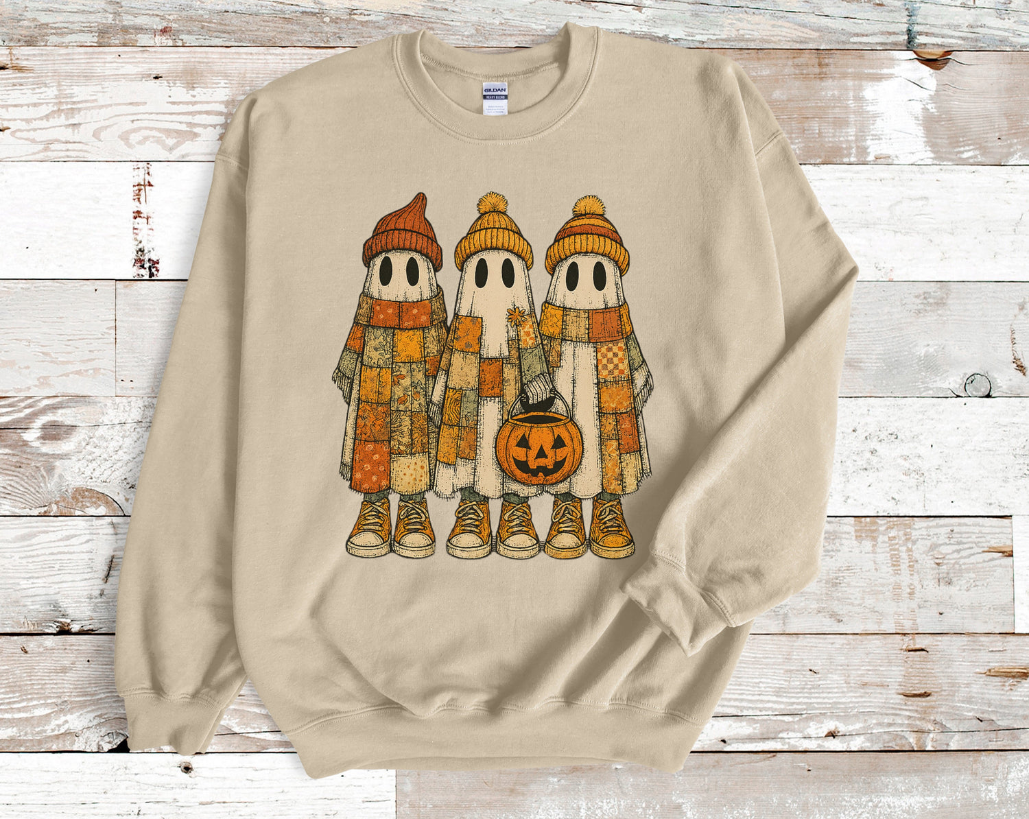 Two cute mummies sitting by a fire under stars and a moon on a black Fall t-shirt design.