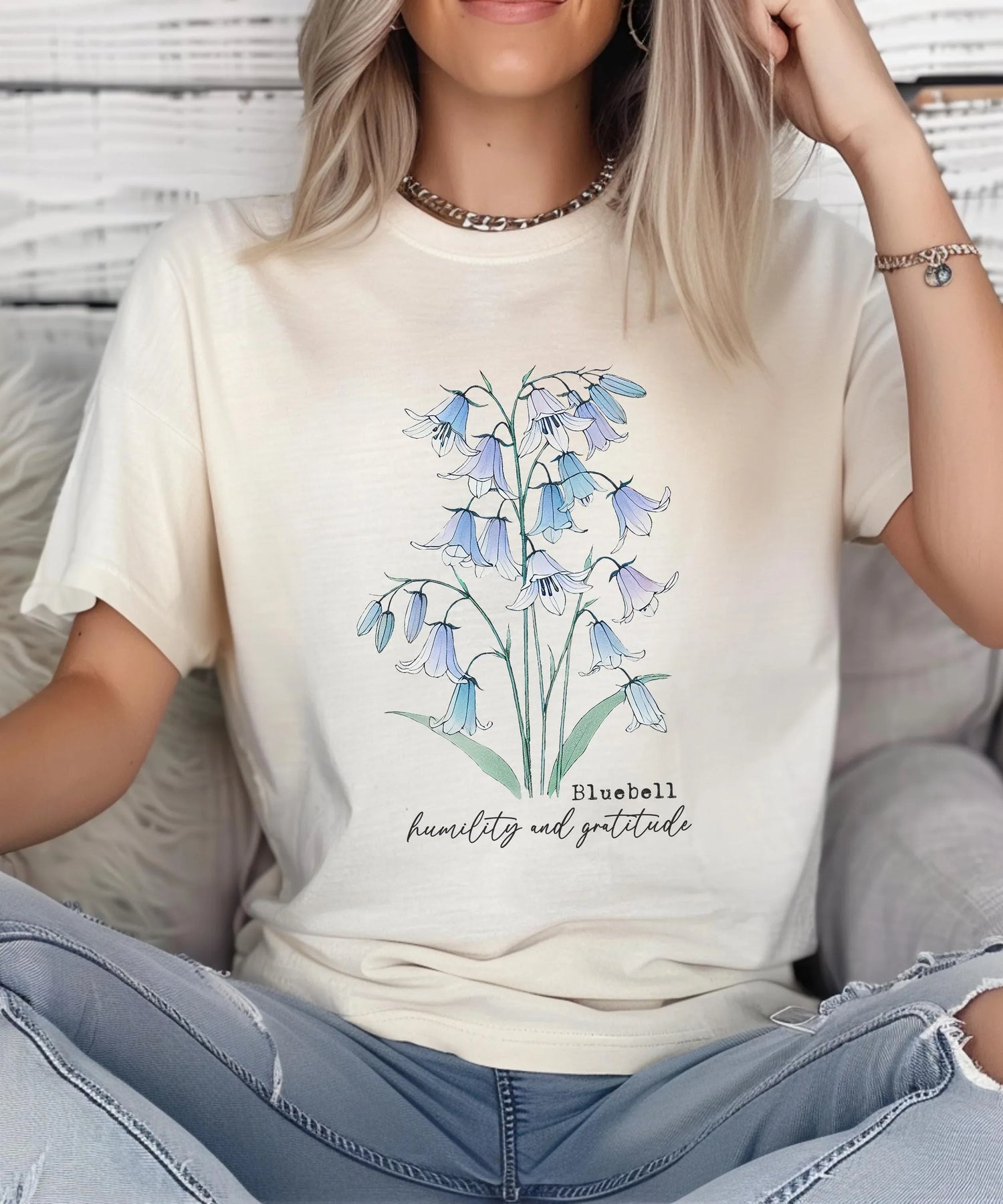 Woman wearing a cream t-shirt featuring a bluebell graphic, capturing the essence of Gardening and nature appreciation.